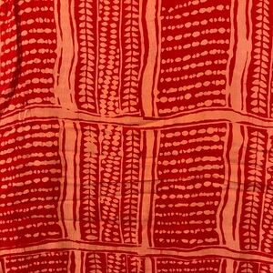 Patterned Pareo in red -orange and coral. NWOT.